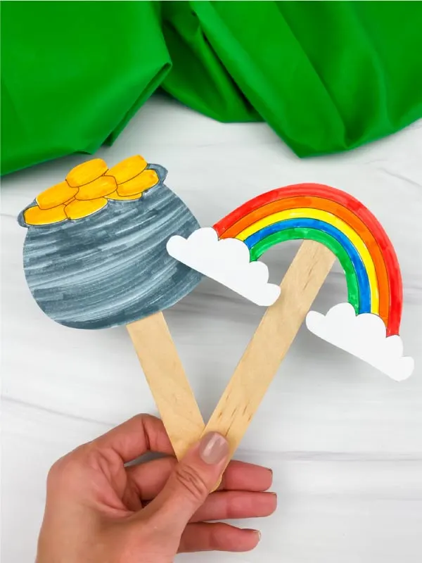 hand holding St. Patrick's Day popsicle stick puppets