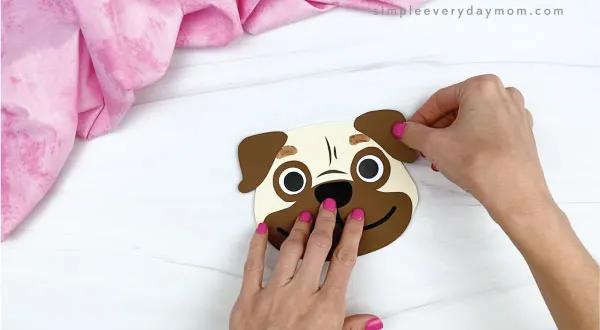 hands gluing ears onto puppy valentine craft