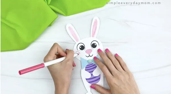 hand coloring cheeks onto paper bunny craft