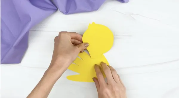 hands gluing head to handprint duck craft