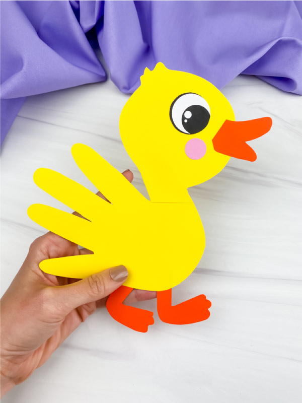 hand holding handprint duck craft