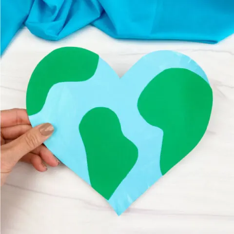 hand holding heart shaped paper plate Earth craft