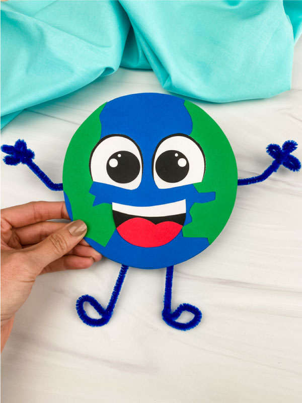 hand holding paper Earth craft