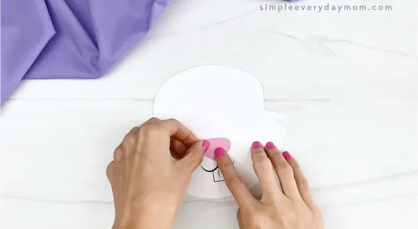 hand gluing nose to handprint easter bunny craft