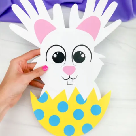 hand holding handprint easter bunny craft