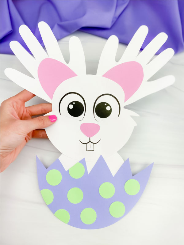 hand holding handprint easter bunny craft