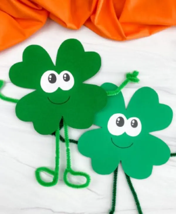 Vertical image of two example of finished shamrock crafts with orange fabric at the top
