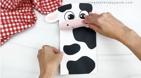 hand gluing body to paper bag cow craft