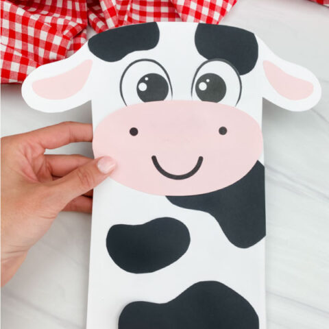 hand holding paper bag cow craft