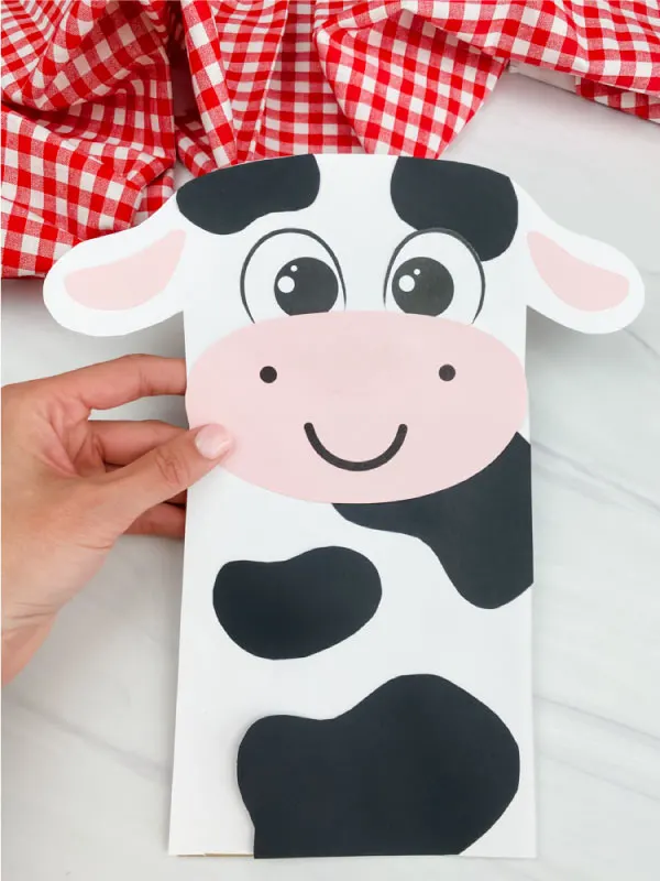 hand holding paper bag cow craft