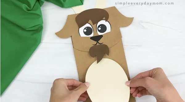 hand gluing belly to paper bag goat craft