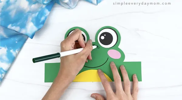 hand drawing spots on frog headband craft
