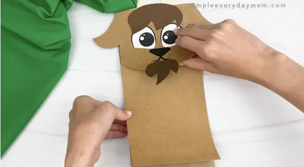 hand gluing body to paper bag goat craft