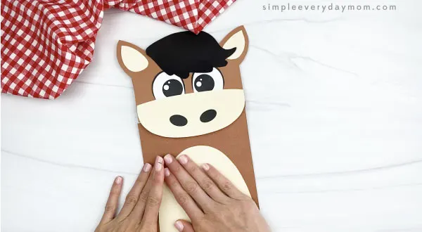 hand gluing belly to paper bag horse craft