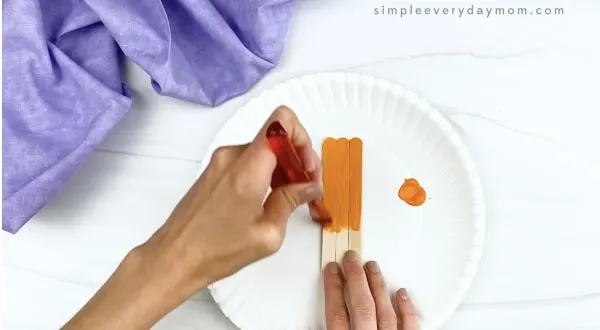 hand painting popsicle stick orange