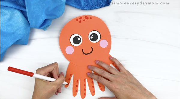 hand drawing suckers on handprint octopus