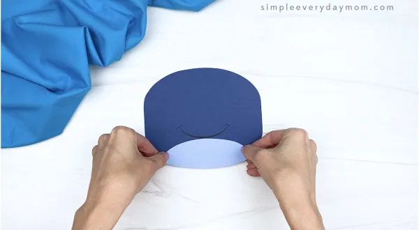 hand gluing belly onto paper plate whale craft