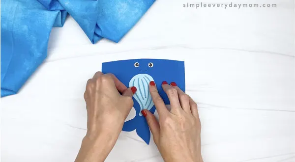 hand gluing belly to toilet paper roll humpback whale craft