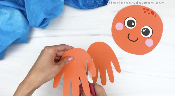 hand cutting thumb off of orange handprint