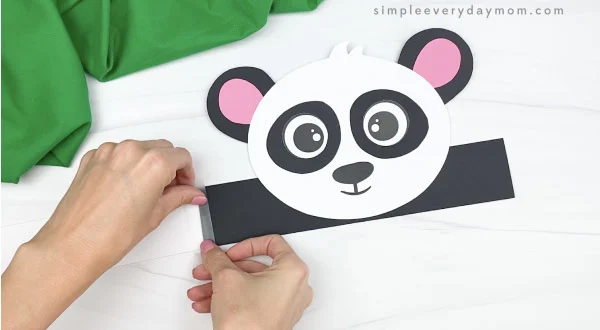 hand taping extenders to panda headband craft