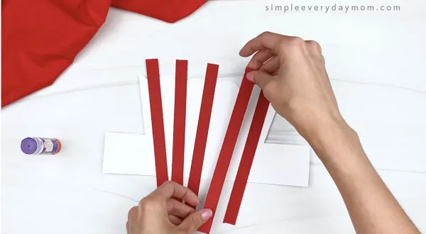 hand gluing stripes to popcorn headband craft