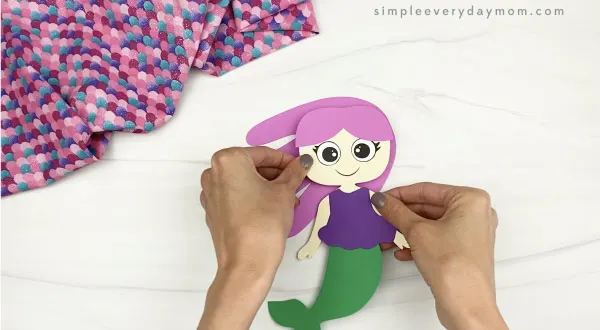hand gluing hair to handprint mermaid craft