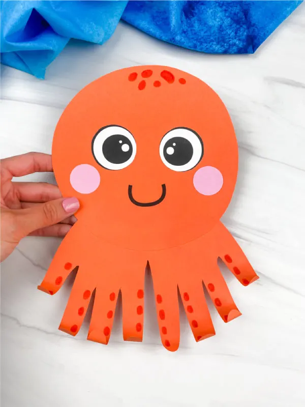 hand holding handprint octopus craft
