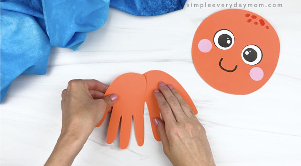 hand gluing handprint together for handprint octopus