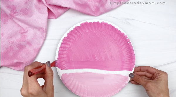 hand painting paper plate in two shades of pink