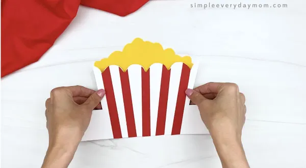 hand gluing popcorn to popcorn headband craft
