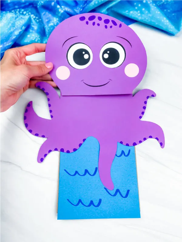 hand holding paper bag octopus craft