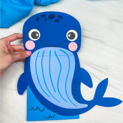 hand holding paper bag whale craft