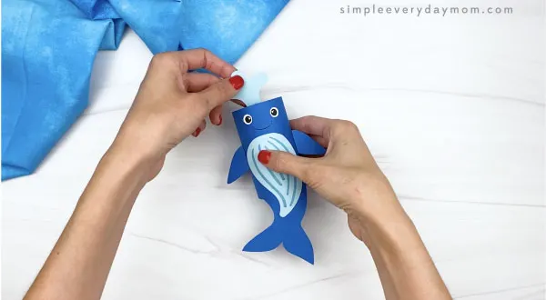 hand gluing water to top of toilet paper roll humpback whale craft