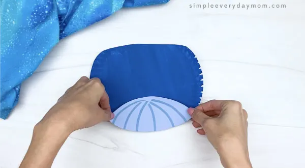 hand gluing belly onto paper plate whale craft