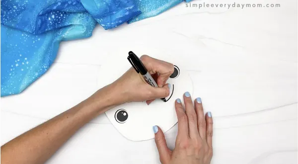 hand drawing mouth onto paper plate beluga whale craft