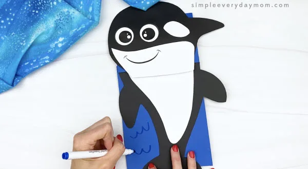 hand drawing water on orca paper bag craft