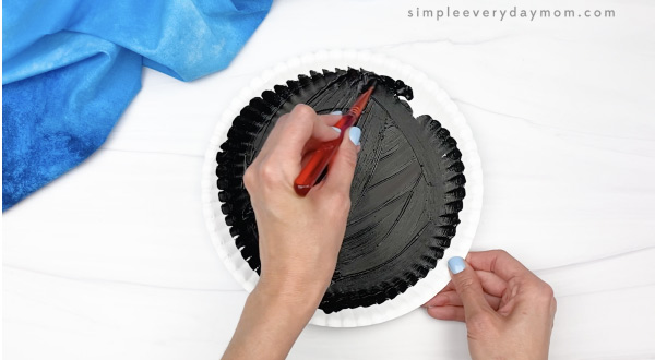 hand painting paper plate black
