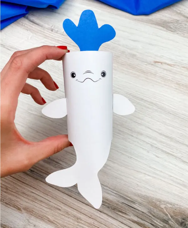 hand holding toilet paper roll beluga whale craft