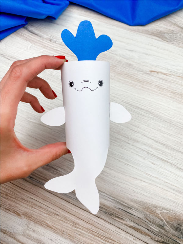 hand holding toilet paper roll beluga whale craft