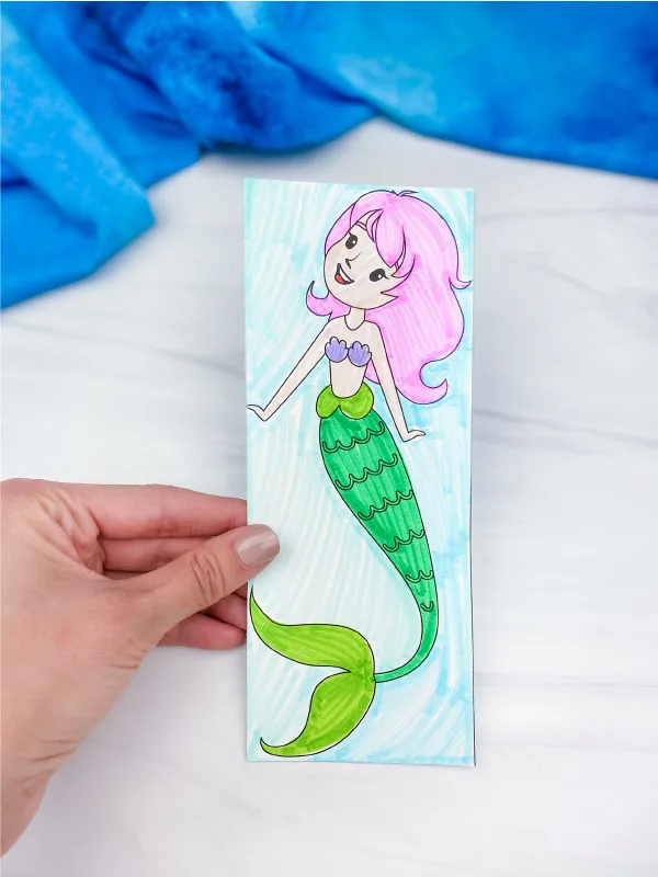 hand holding coloring page mermaid bookmark