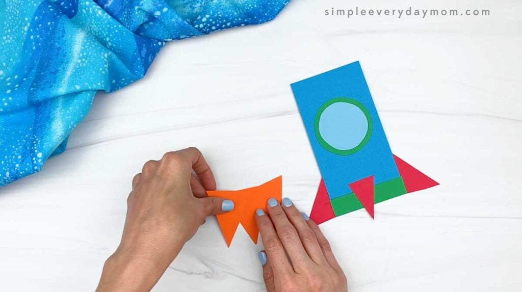hands gluing the triangle flames together