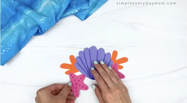 hand gluing starfish to mermaid headband craft