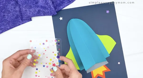 hand placing star stickers on paper