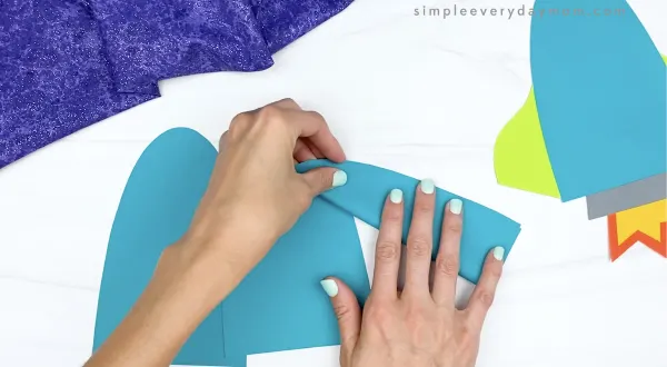 hand folding paper pieces in half