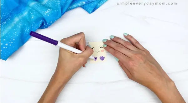 hand drawing mermaid top onto popsicle stick mermaid