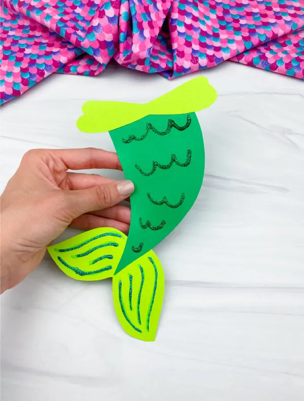 hand holding green mermaid tail craft