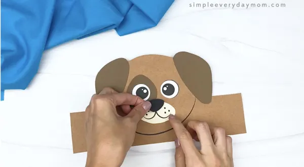 hand gluing nose to dog headband craft