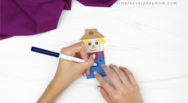 hand coloring pocket onto popsicle stick scarecrow craft