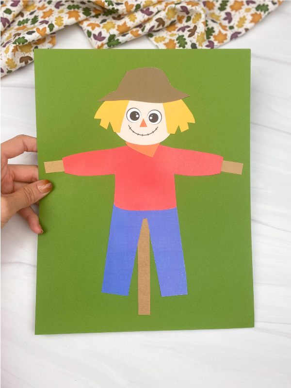 hand holding printable scarecrow craft