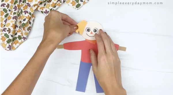 hand gluing hair to printable scarecrow craft